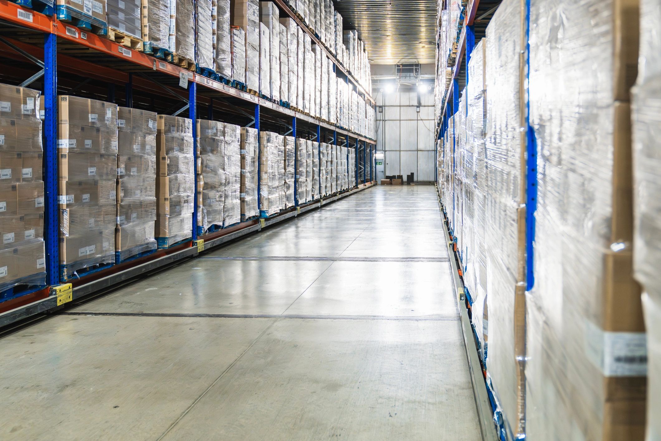 Palletized boxes in a cold storage logistics warehouse aisle